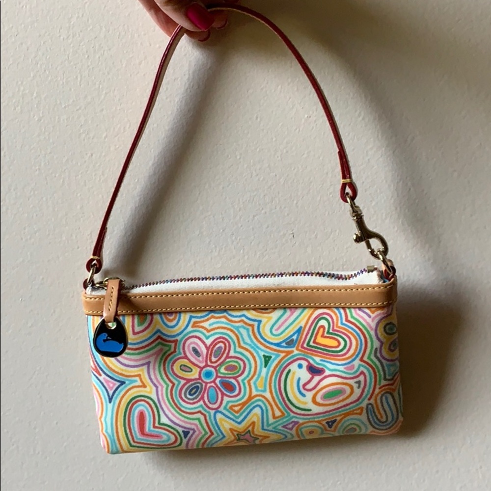 Dooney & Bourke tan wristlet with zipper.